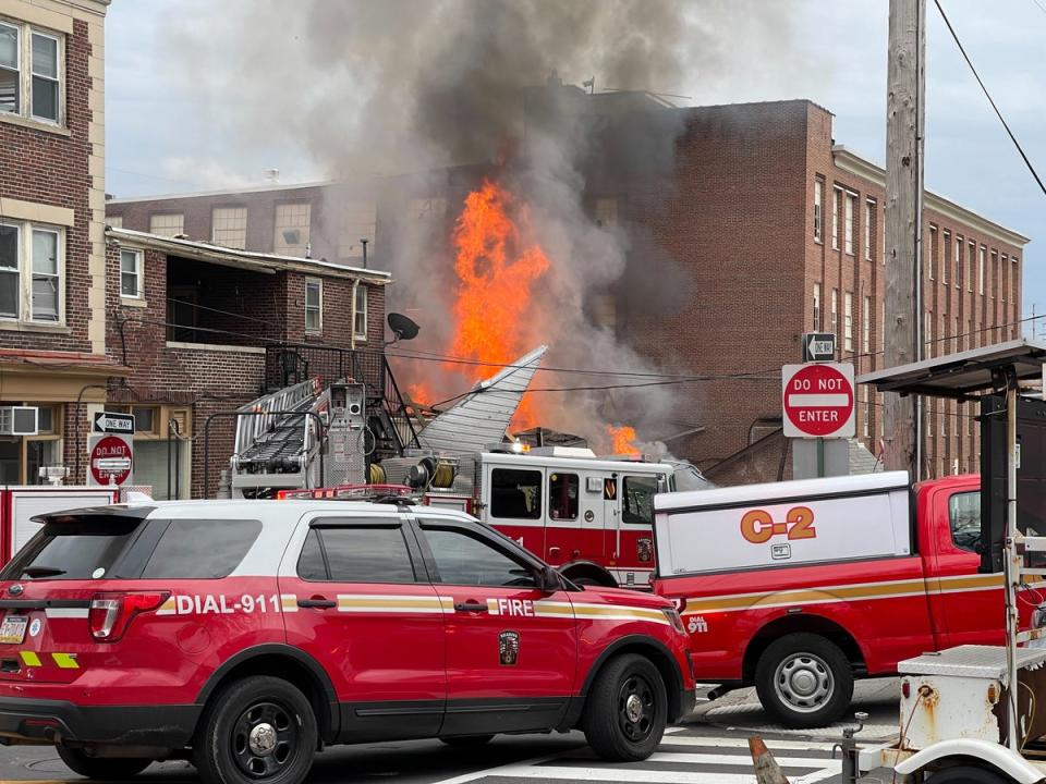 Emergency personnel work at the site of a deadly explosion at a chocolate factory in West Reading, Pa., Saturday, March 25, 2023 (AP)