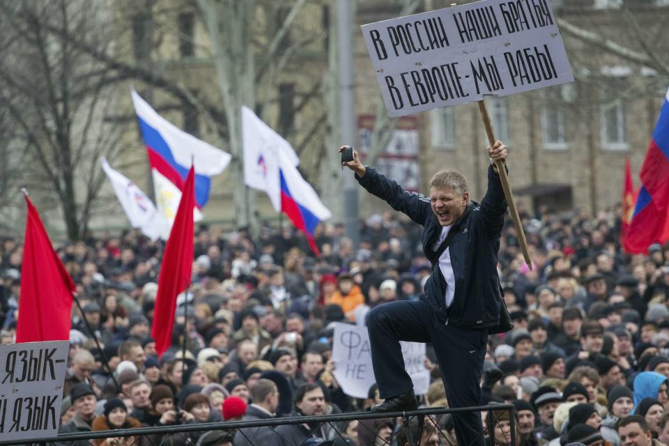 Pro-Russian protesters with Russian flags take part in a rally in central Donetsk