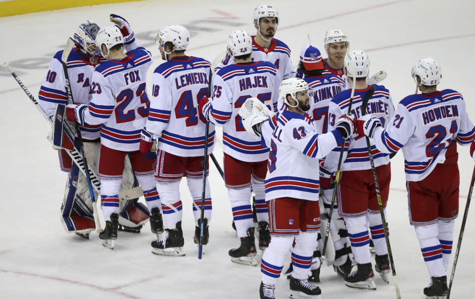 New York Rangers celebrate with goaltender Alexandar Georgiev (40, left) after their 6-3 win over the New Jersey Devils in an NHL hockey game in Newark N.J., on Saturday, March 6, 2021. (Andrew Mills/NJ Advance Media via AP)