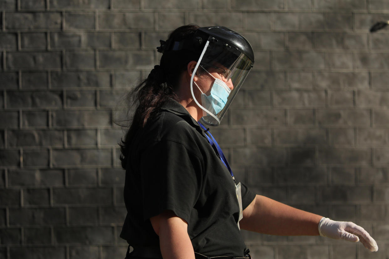 LONDON, April 16, 2020.A cleaner wearing face mask leaves 10 Downing Street in London, Britain, on April 16, 2020. The British government announced on Thursday that the current restrictive measures that aim to contain the spread of the novel coronavirus will remain in place for "at least three weeks".  As of Thursday morning, 103,093 people in Britain tested positive for COVID-19, said the Department of Health and Social Care. (Photo by Tim Ireland/Xinhua via Getty) (Xinhua/ via Getty Images)