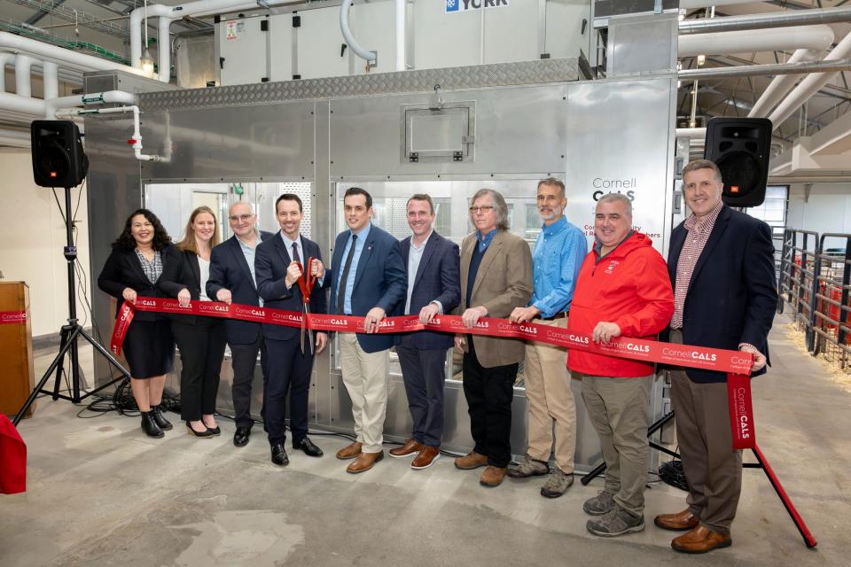 Joseph McFadden and Cornell Dean of the university's College of Agriculture and Life Sciences Benjamin Houlton cut a ribbon on Thursday, April 18, to honor the opening of four new animal emissions chambers, surrounded by community stakeholders.