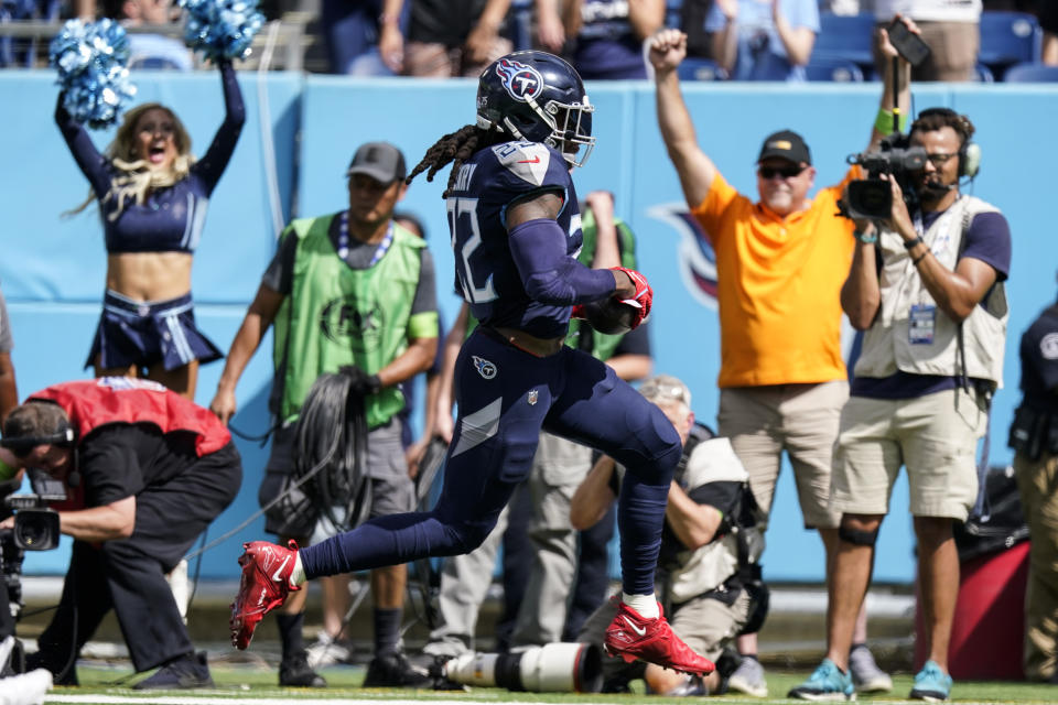 Tennessee Titans running back Derrick Henry (22) runs into the end zone for a touchdown agaimnst Cincinnati Bengals cornerback DJ Turner II (20) during the first half of an NFL football game, Sunday, Oct. 1, 2023, in Nashville, Tenn. (AP Photo/George Walker IV)