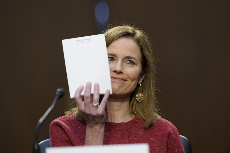 Supreme Court nominee Amy Coney Barrett speaks during a confirmation hearing before the Senate Judiciary Committee, Tuesday, Oct. 13, 2020, on Capitol Hill in Washington. Sen. John Cornyn, R-Texas, asked Barrett what notes she was referring to during the hearing and she held up the blank pad of paper. (AP Photo/Susan Walsh, Pool)