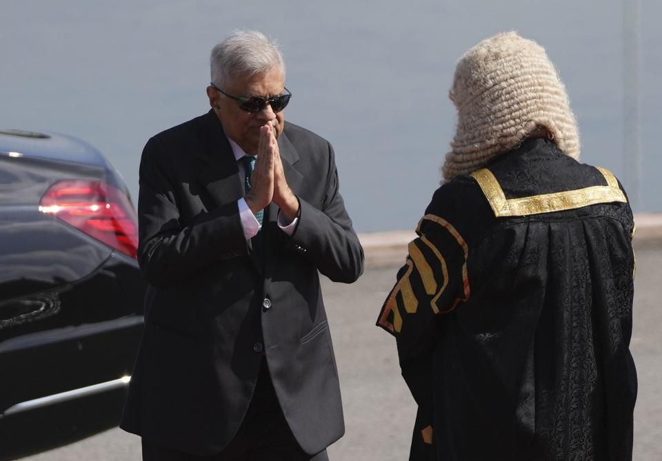 Sri Lankan president Ranil Wickremesinghe, left, greets speaker Mahinda Yapa Abeywardena as he arrives at the parliament to deliver his policy speech in Colombo, Sri Lanka, Wednesday, Feb. 8, 2023. Wickremesinghe on Wednesday appealed for patience amid the country's worst economic crisis but promised brighter times ahead. (AP Photo/Eranga Jayawardena)