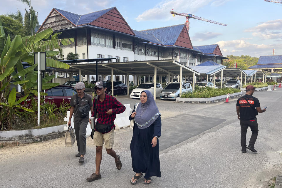 Residents walk out from the Sultanah Maliha Hospital, where King Harald V of Norway is believed to be admitted with an infection, on the Malaysian resort island of Langkawi, Malaysia, Wednesday, Feb. 28, 2024. Malaysian national news agency Bernama cited unidentified sources as confirming that Europe's oldest monarch was warded at the hospital’s Royal Suite. (AP Photo/Vincent Thian)