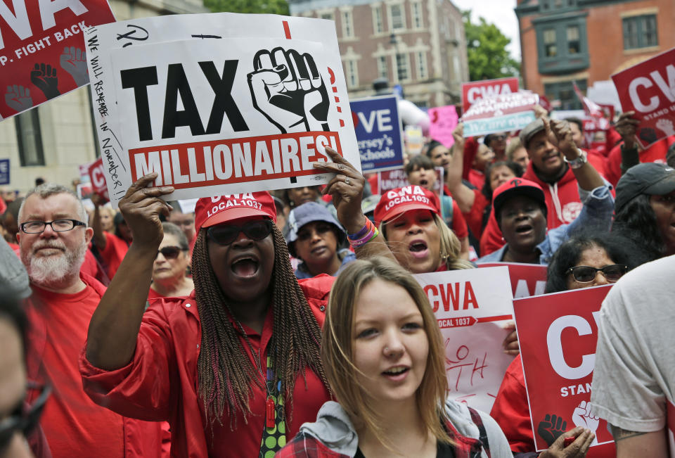 Protesters rally against benefit cuts in Trenton, N.J., Thursday, June 13, 2019. Spurred on by a tweet from U.S. Sen. Bernie Sanders, thousands of union members crowded around New Jersey's legislative annex Thursday, even spilling into the street, to protest state Senate President Steve Sweeney's calls to cut some worker benefits. (AP Photo/Seth Wenig)