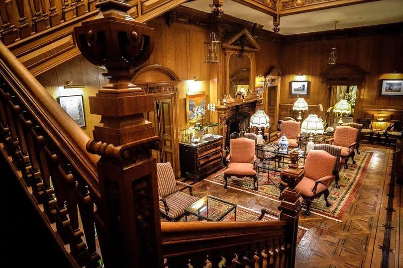 The main hall of Palé Hall adorned with wooden panelling and antique furnishing -Credit:Palé Hall