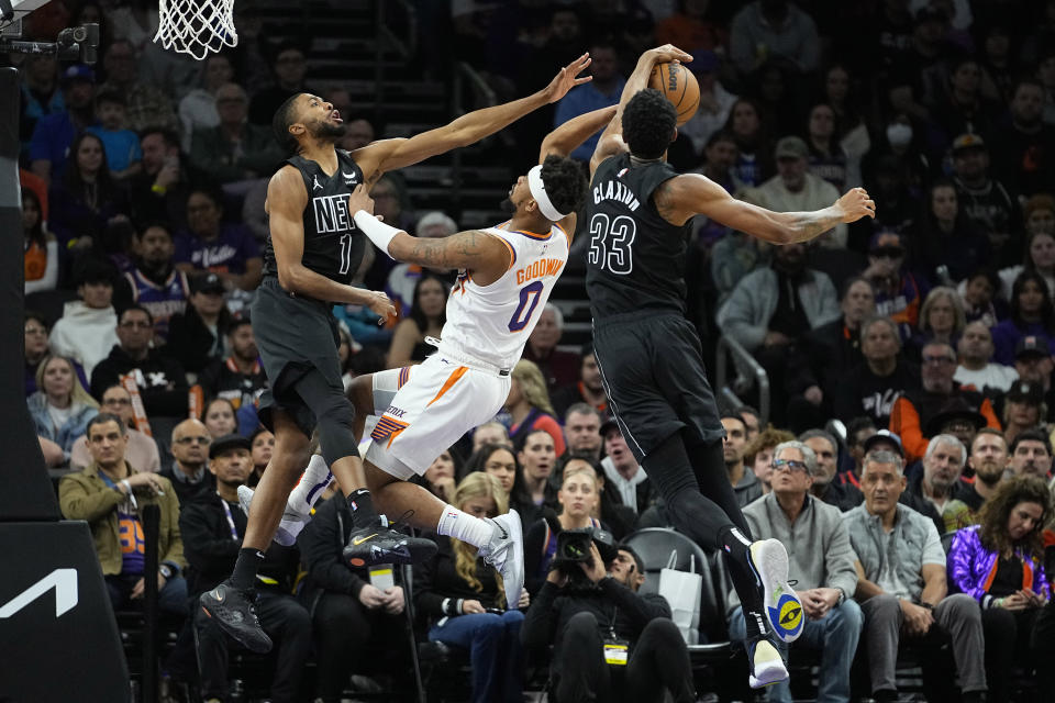 Brooklyn Nets center Nic Claxton (33) blocks the shot of Phoenix Suns guard Jordan Goodwin (0) during the second half of an NBA basketball game, Wednesday, Dec. 13, 2023, in Phoenix. (AP Photo/Matt York)