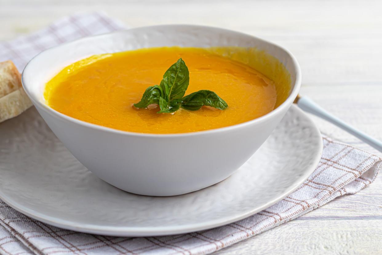 Fresh pumpkin cream soup with sour cream. Autumn lunch concept. A dietary, healthy dish. Copy space.