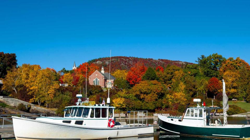 Lobster boats in Camden, Maine Harbor with fall foliage