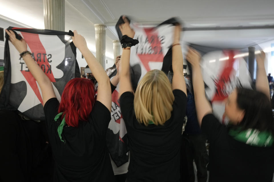 Abortion rights activists react after Poland's parliament voted to continue work on proposals to liberalize Poland's strict abortion law, in Warsaw, Poland, on Friday, April 12, 2024. Polish lawmakers voted Friday to continue work on proposals to lift a near total ban on abortion, a divisive issue in the traditionally Roman Catholic country, which has one of the most restrictive laws in Europe. (AP Photo/Czarek Sokolowski)