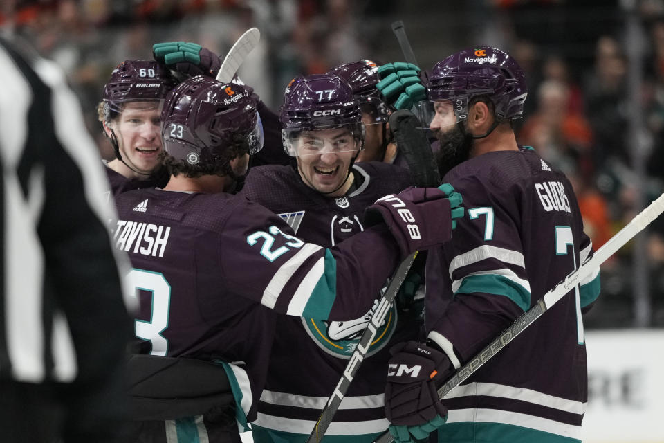 Anaheim Ducks' Frank Vatrano (77) celebrates his hat-trick with teammates during the third period of an NHL hockey game against the Carolina Hurricanes, Sunday, Oct. 15, 2023, in Anaheim, Calif. The Ducks won 6-3. (AP Photo/Jae C. Hong)