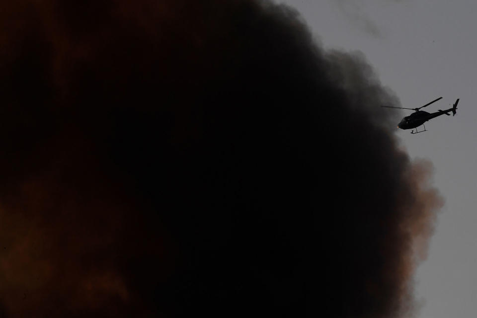 <p>A helicopter is seen as smoke billows from a serious fire in a tower block at Latimer Road in West London, Britain June 14, 2017. (Toby Melville/Reuters) </p>