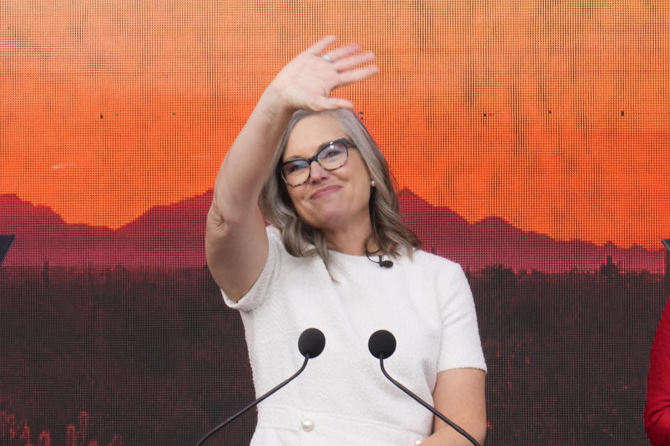 Arizona Democratic Gov. Katie Hobbs waves to cheering supporters after taking the ceremonial oath of office during a public inauguration at the state Capitol in Phoenix, Thursday, Jan. 5, 2023. (AP Photo/Ross D. Franklin)