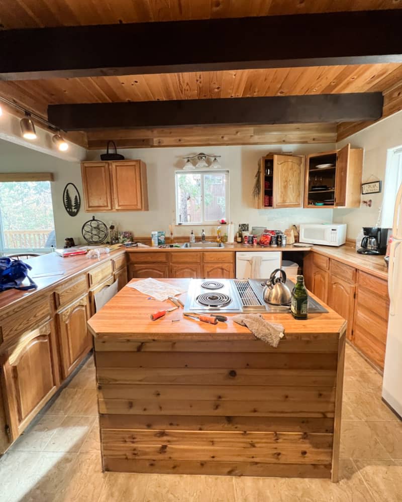 Wooden cabinets in kitchen before renovation.