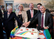 Germany's first married same-sex couple Karl Kreil (3rdR) and Bodo Mende (R) cut a wedding cake after getting married at a registry office following German parliament's approval of marriage equality in a historic vote this past summer, in Berlin, Germany October 1, 2017. REUTERS/Axel Schmidt