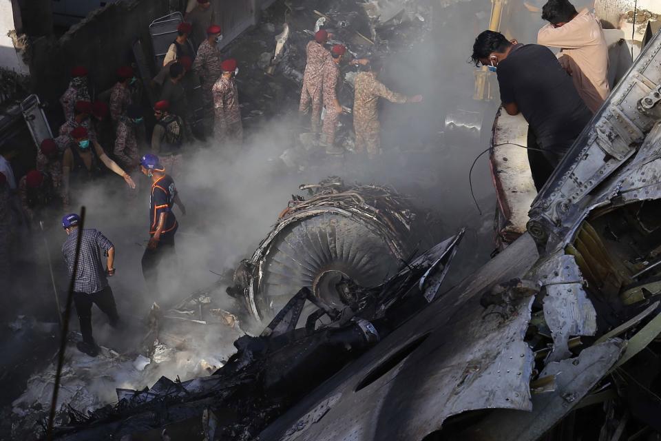 Rescue workers search for bodies and survivors amid the wreckage of the Pakistan International Airlines plane: EPA