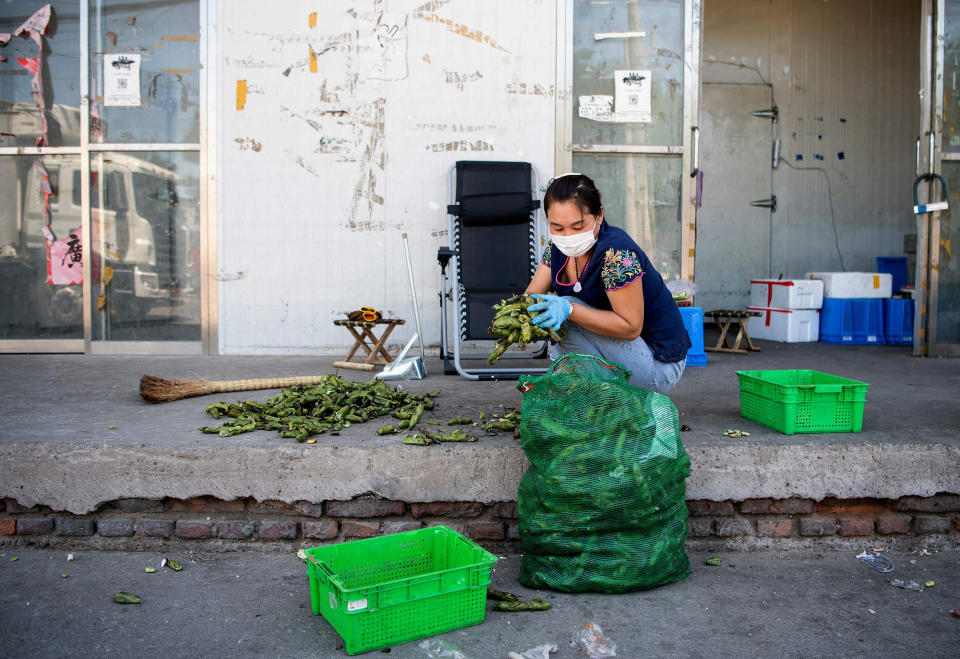 Image: A worker arranges vegetable at the closed Xinfadi Market in Beijing (Noel Celis / AFP - Getty Images)