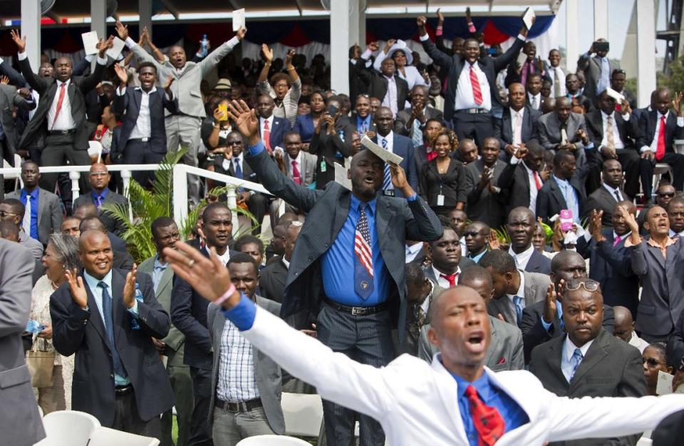 Supporters of Haiti's new President Jovenel Moise cheer as he speaks at the National Palace during his inauguration ceremony in Port-au-Prince, Haiti, Tuesday Feb. 7, 2017. Moise was sworn as president for the next five years after a bruising two-year election cycle, inheriting a struggling economy and a deeply divided society. (AP Photo/Dieu Nalio Chery)