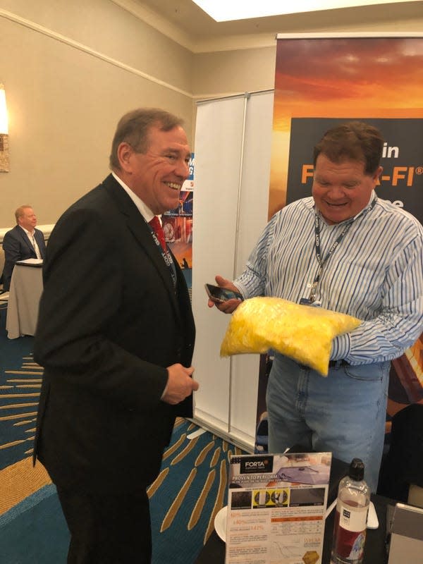 U.S. Rep. Neal Dunn, R-Panama City, speaks with Roger Linde of Forta Corporation, a Pennsylvania-based company that produces synthetic fibers to strengthen asphalt, concrete and other construction materials, during the recent Air Force Contracting Summit in Miramar Beach. Linde is showing Dunn a package of Forta's synthetic fibers.