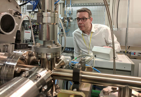 Professor John McGeehan, an X-ray Crystallographer at the University of Portsmouth, stands next to equipment at the Diamond Light Source, the UK national synchrotron, that he used to reveal the atomic structure of an enzyme his team has subsequently engineered that can digest a common form of plastic and may in future help in the fight against pollution, in Didcot, Britain, April 13, 2018. REUTERS/Stuart McDill