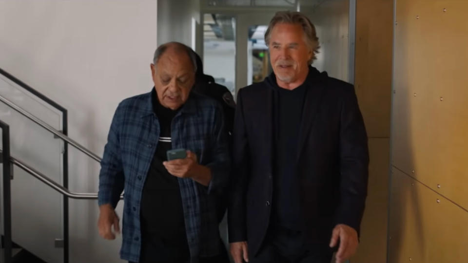 Don Johnson smiles while Cheech Marin checks his phone as they walk in Nash Bridges.