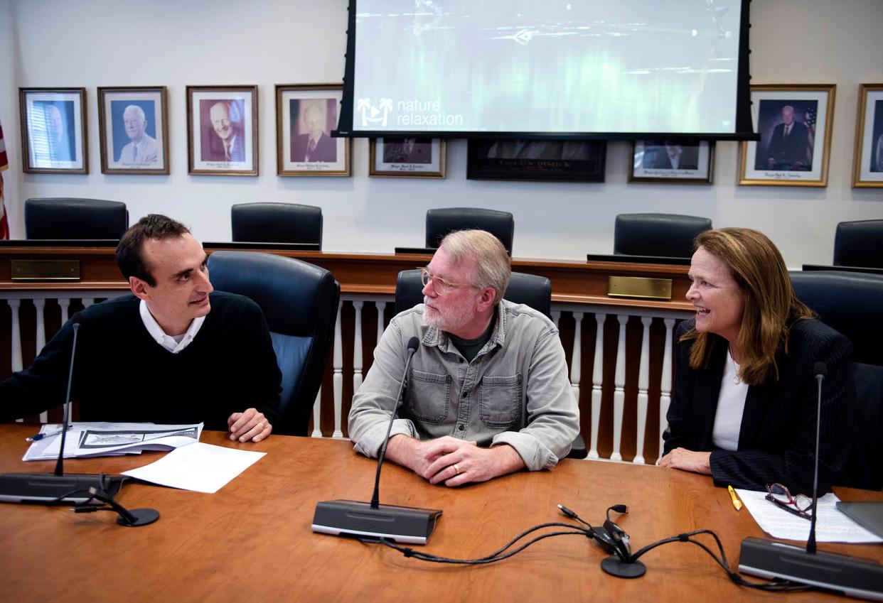 Katie Carpenter, right, serves as the moderator for Drs. Ray Dorsey, left, and Bruce Lanphear during "Where Have All the Songbirds Gone?" III at Town Hall on Monday.