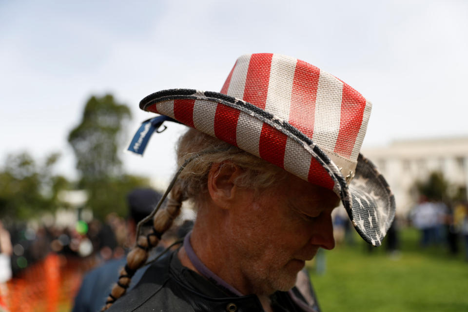 A demonstrator in support of U.S. President Donald Trump wears a hat with an American flag during rally and counter-demonstration in Berkeley, California in Berkeley, California, U.S., April 15, 2017. REUTERS/Stephen Lam