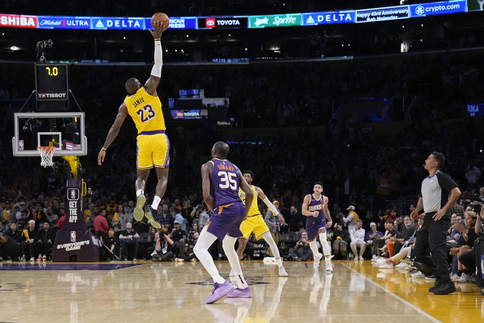 Los Angeles Lakers forward LeBron James (23) reaches for a inbound pass intended for Phoenix Suns forward Kevin Durant (35) during the second half of an NBA basketball game Thursday, Oct. 26, 2023, in Los Angeles. (AP Photo/Mark J. Terrill)