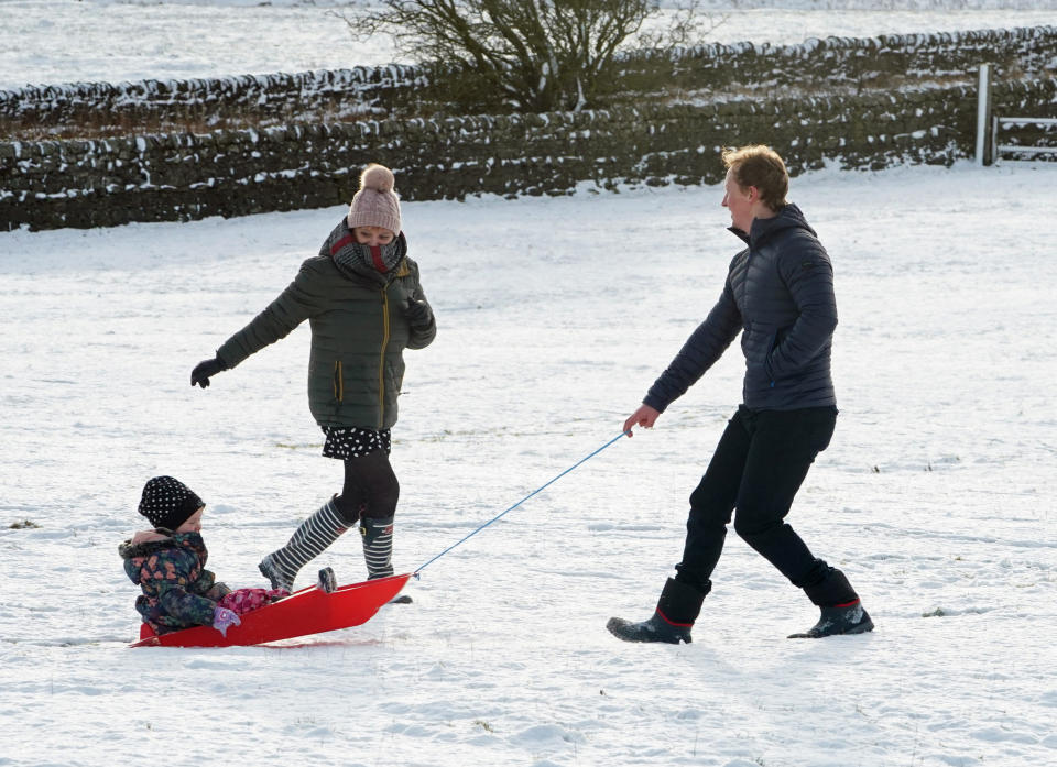 A family take advantage of the Christmas Day snow with a trip out sledging on the hills near Hexham, Northumberland. Early morning snowfall has been recorded in parts of the UK, with the Met Office declaring it a White Christmas.