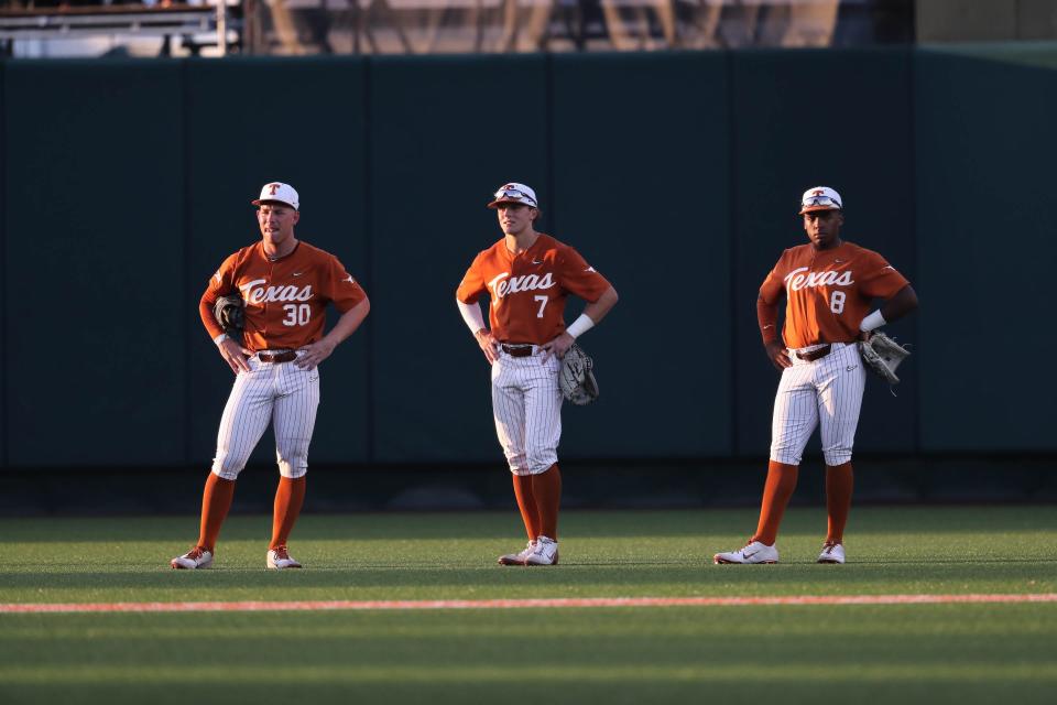 Texas outfielders, from left, Eric Kennedy, Douglas Hodo III and Dylan Campbell wait for a replay review during their 2022 NCAA regional game against Louisiana Tech. Hodo was drafted last year, but Kennedy and Campbell have become key players on this year's team.