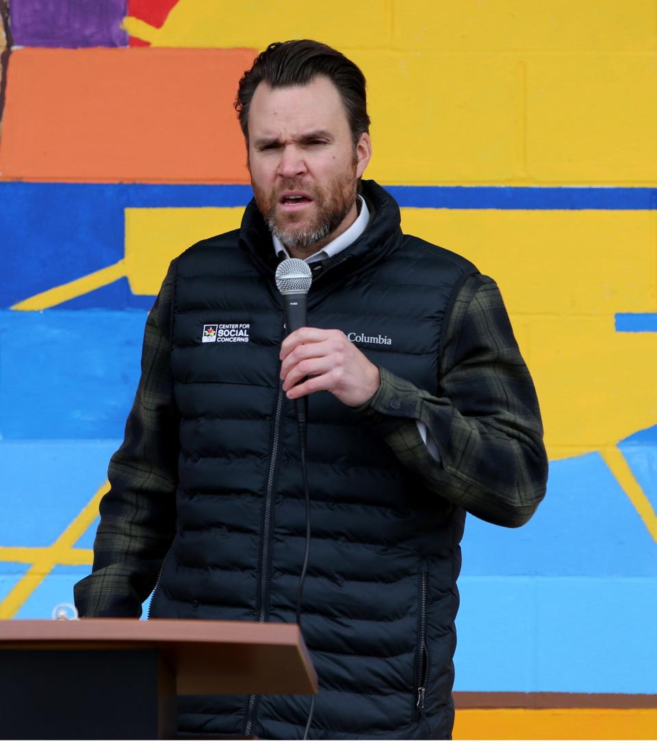 Mike Hebbeler, program director of the University of Notre Dame's Center for Social Concerns, speaks at the dedication Dec. 12, 2022, of a mural on the La Casa de Amistad building at 3423 S. Michigan St. in South Bend.