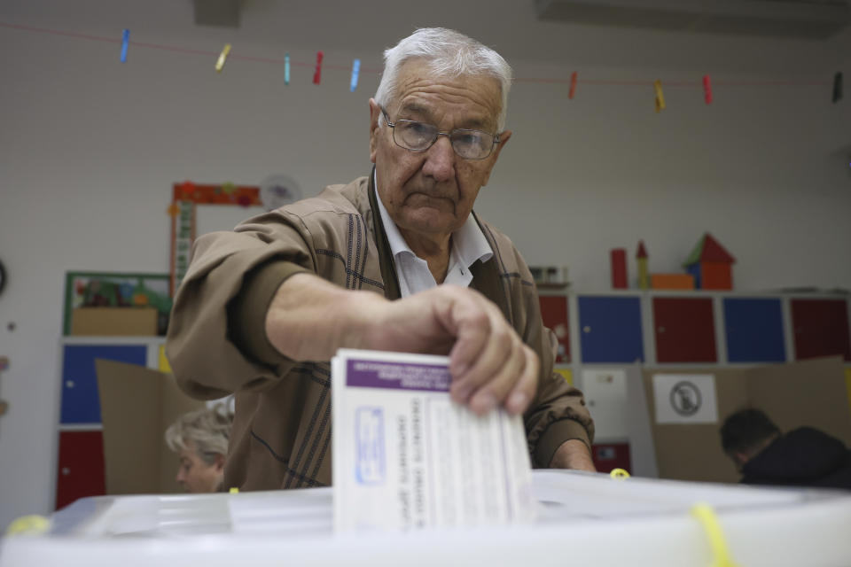 Bosnian man casts his vote at a poling station in Sarajevo, Bosnia, Sunday, Oct. 2, 2022. Polls opened Sunday in Bosnia for a general election that is unlikely to bring any structural change despite palpable disappointment in the small, ethnically divided Balkan country with the long-established cast of sectarian political leaders. (AP Photo/Armin Durgut)