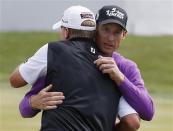 Jim Furyk (R) of U.S. hugs compatriot Steve Stricker after finishing the final round of the BMW Championship golf tournament at the Conway Farms Golf Club in Lake Forest, Illinois, September 16, 2013. REUTERS/Jim Young