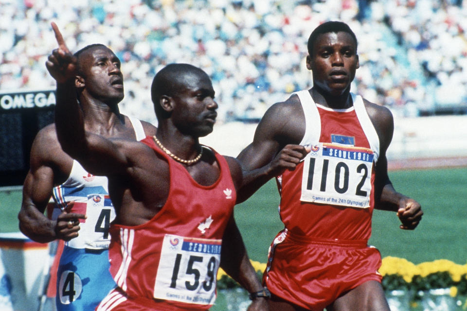 FILE - In this Sept. 25, 1988, file photo, Canadian Ben Johnson, left, signals victory ahead of the United States' Carl Lewis, as he wins the 100-meter final at the Summer Olympic Games in Seoul, South Korea. (AP Photo/Rick Wilking, File)