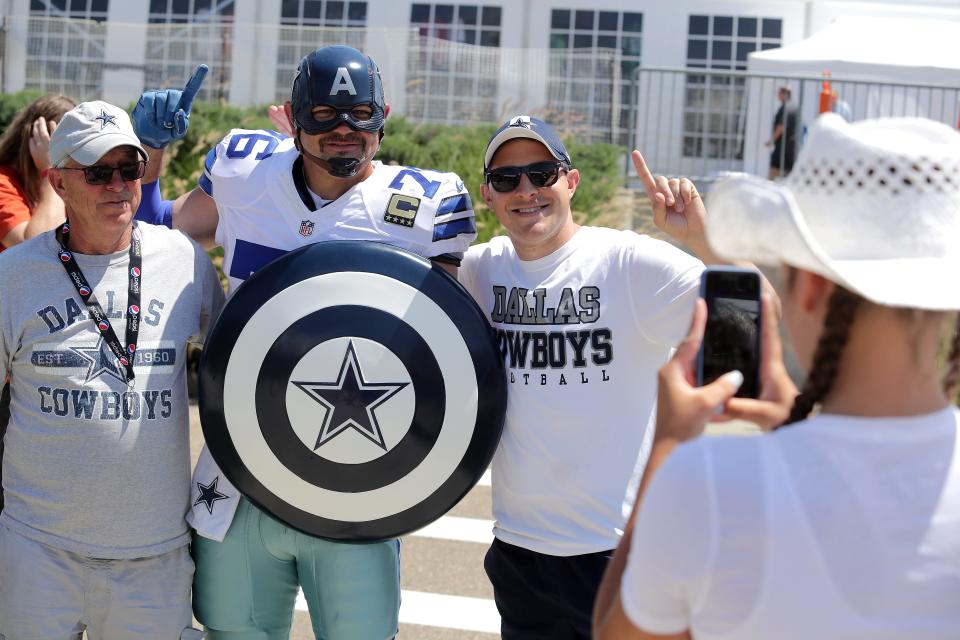 Eric Welborn, aka, Captain America's Team, of Elkin, North Carolina, poses for a snapshot with Denny Clark, left, and his son Danny Clark of State College, Pennsylvania, at the Pro Football Hall of Fame Fun Fest.