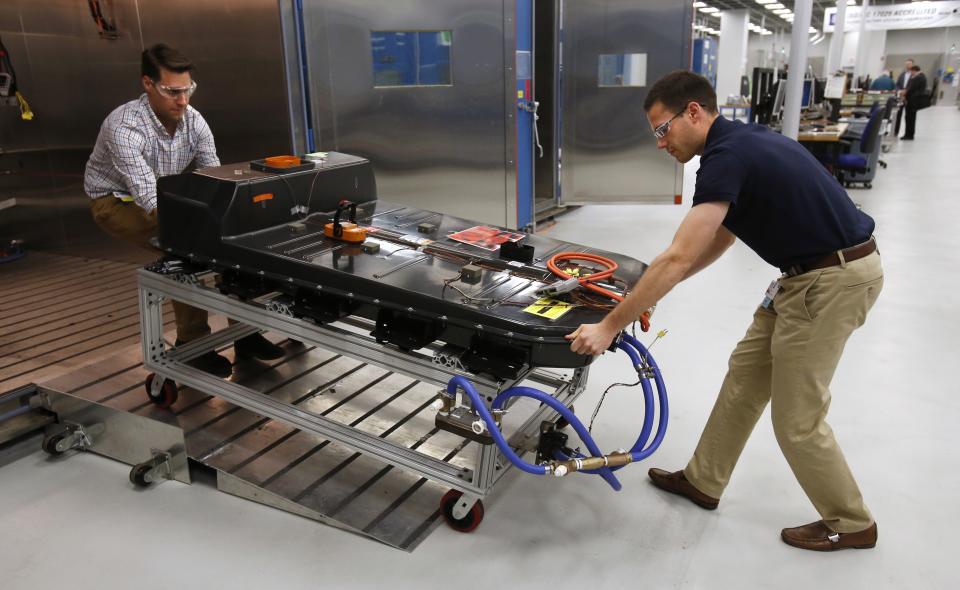 FILE- In this Nov. 4, 2016, file photo, a Chevrolet Bolt EV battery pack is removed for testing after undergoing charging and discharging cycles at General Motors Warren Technical Center's Advanced Energy Center in Warren, Mich. If U.S. consumers ever ditch fuel burners for electric vehicles, then the United Auto Workers union is in trouble. Gone would be thousands of jobs at engine and transmission plants across the industrial Midwest, replaced by smaller workforces at squeaky-clean mostly automated factories that mix up chemicals to make batteries. (AP Photo/Duane Burleson, File)