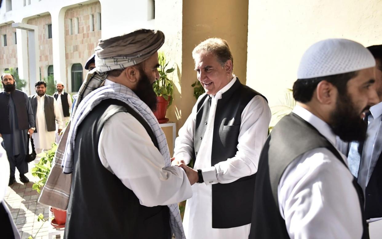 Pakistan's Foreign Minister Shah Mehmood Qureshi (centre R) receives members of the Taliban delegation at the Pakistan Foreign Ministry in Islamabad on October 3 - AFP