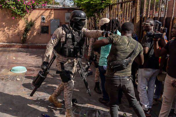 PHOTO: A police officer prevents protesters from entering a hotel that was just looted during a protest against Haitian Prime Minister Ariel Henry calling for his resignation, in Port-au-Prince, Haiti, Oct. 10, 2022.  (Richard Pierrin/AFP via Getty Images)