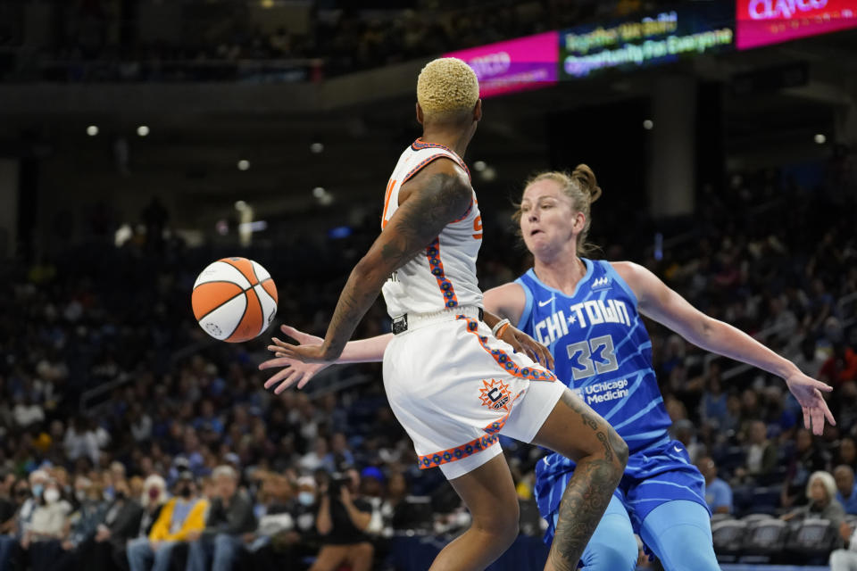 Connecticut Sun's Courtney Williams passes behind her back as Chicago Sky's Emma Meesseman defends during the first half of Game 5 in a WNBA basketball playoffs semifinal Thursday, Sept. 8, 2022, in Chicago. (AP Photo/Charles Rex Arbogast)