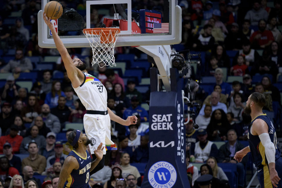 Minnesota Timberwolves center Rudy Gobert (27) makes a basket over New Orleans Pelicans forward Naji Marshall (8) during the first half of an NBA basketball game in New Orleans, Wednesday, Jan. 25, 2023. (AP Photo/Matthew Hinton)