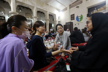 Japanese tourists talk to an Emirati woman volunteer to learn about Ramadan and Emirati culture during the Muslim holy fasting month of Ramadan, at the Sheikh Mohammed Centre for Cultural Understanding (SMCCU) in Dubai, UAE May 17, 2019. REUTERS/Satish Kumar