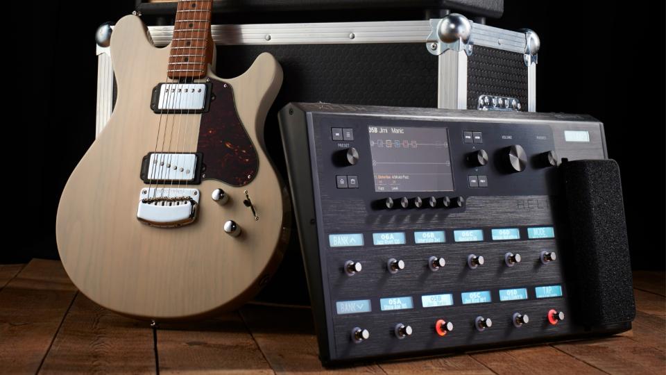 An electric guitar and multi-effects pedal resting against a flight case