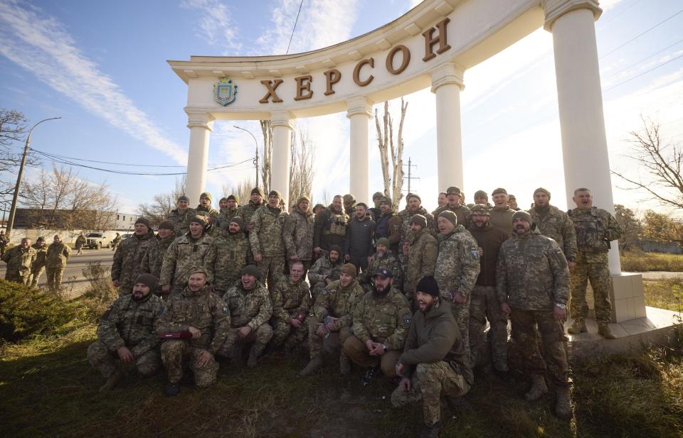 FILE - In this photo provided by the Ukrainian Presidential Press Office and posted on Facebook, Ukrainian soldiers pose for a photo with President Volodymyr Zelenskyy, center top, during his visit to Kherson, Ukraine, Monday, Nov. 14, 2022. Ukraine's retaking of Kherson was a significant setback for the Kremlin and it came some six weeks after Russian President Vladimir Putin annexed the Kherson region and three other provinces in southern and eastern Ukraine — in breach of international law — and declared them Russian territory. (Ukrainian Presidential Press Office via AP, File)