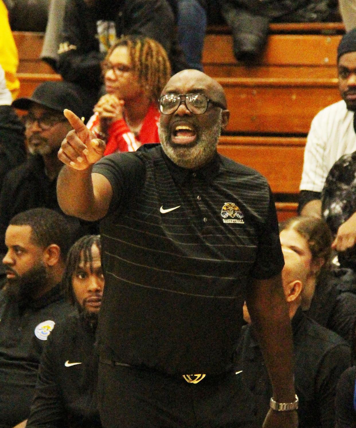 Simeon head coach Robert Smith shouts out instructions during the championship game of the Pontiac Holiday Tournament. Smith's Wolverines won the title for the 11th time under his guidance and 16th time overall.