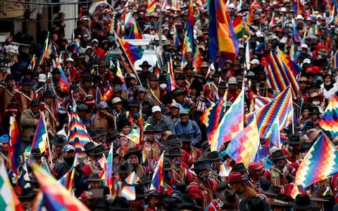 Evo Morales supporters march in La Paz on Thursday - Credit: Natacha Pisarenko/AP