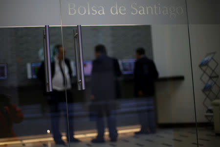 Traders use electronics board showing stock information at Santiago's stock exchange in Santiago, Chile September 25, 2017. REUTERS/Ivan Alvarado