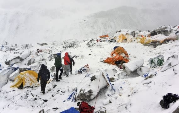 Climbers search through crushed tents at base camp for fellow survivors. Photo credit: aawsat.net