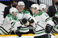 Dallas Stars defenseman Jamie Oleksiak (2) is congratulated by Joel Hanley (44) and Esa Lindell (23) after scoring a goal against the Nashville Predators in the second period of an NHL hockey game Sunday, April 11, 2021, in Nashville, Tenn. (AP Photo/Mark Humphrey)