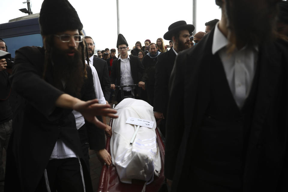 The body of Eliyahu Kay, a 26-year-old immigrant to Israel from South Africa, is carried during his funeral the day after he was killed when a Palestinian man opened fire in the Old City of Jerusalem, Monday, Nov. 22, 2021, in Jerusalem. (AP Photo/Oded Balilty)